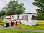 Come see all this well-maintained and cozy home has to offer, fully furnished and perfect for your summer getaway. This amazing summer home offers a Summer Day Camp for children from ages three to fourteen years old and is offered at a very reasonable price. Be sure to check out the fresh appearance with the Nursery play area, beautiful camp playground, manicured grounds, and state-of-the-art sports facilities. Bring your family to the Lansmans and start making memories. Lansmans Co-op was established in 1985 and was originally founded by the Lansmans in 1942 as a rental bungalow colony. The Co-op is situated on 100 beautiful, wooded acres in Woodbourne, NY. Lansmans offers an Olympic-sized, heated swimming pool, tennis courts, a full-size basketball court, paddleball courts, a pickleball court, a volleyball court, and a baseball field. In addition to all the fabulous amenities, an air-conditioned card room with exercise equipment and a full-service Concession for dining is available. Every weekend, enjoy some entertainment in the beautiful Lansman Playhouse.Located just a short drive from local eateries, shops, and entertainment, and also within reach of Resorts World Catskills Casino, YO1 Wellness Center, and Bethel Woods Center for the Arts. This amazing opportunity won&rsquo;t last long so book your showing today and see all this summer home has to offer.
