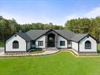 Experience refined living at this 4-year-young luxury estate in Coxsackie, NY. Offering the ease of one-level living, this home spans nearly 7, 200 sq ft, including 3, 400 sq ft of beautifully finished walkout basement. Set on 14 private acres, the residence showcases 4 bedrooms, 3.5 baths, a private office, and a 4-car garage, blending sophistication, comfort, and modern design. Soaring ceilings, walls of glass, and sun-drenched interiors frame sweeping views of the surrounding landscape, creating an atmosphere of elegance and light. The gourmet kitchen is a chefâ€™s dream, complemented by a serene primary suite and generously sized bedrooms. The lower level extends the living space with a private bedroom and full bath â€” ideal for guests, a nanny, or an in-law suite. Additional appointments include a whole house generator and a fiberglass deck that fully covers the patio, seamlessly connecting indoor and outdoor living. The grounds are a private sanctuary, showcasing a picturesque koi-filled pond, manicured acreage, and ample space for recreation or quiet retreat. Perfectly positioned near a premier golf course, the Hudson River, charming villages, and with seamless access to the NYS Thruway, this estate offers both exclusivity and convenience. A rare opportunity to acquire a sophisticated Hudson Valley retreat designed for luxurious one-level living and effortless entertaining.