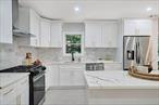 Welcome to this beautifully remodeled 4-bedroom, 4-bath colonial in Northport. Thoughtfully designed with multiple living areas and a private guest quarter complete with its own accessory kitchen and laundry, the home is ideal for multigenerational living, a motherâ€“daughter setup (with proper permits), or even a turnkey Airbnb given Northportâ€™s year-round tourism attraction.The open, airy floor plan is filled with natural light and accented by contemporary finishes throughout. The updated kitchen features stainless steel appliances, sleek cabinetry, and a seamless flow into the sun-filled dining area and spacious living room. The primary suite is a true retreat with its own ensuite bath and private balcony overlooking the tranquil, wooded grounds. A bright sunroom and extra entertainment space provide plenty of room for gatherings, game nights, or quiet evenings at home.Tucked away from the road and accessed by a long private driveway, this home offers the rare combination of privacy & modern comfort. All of this is just minutes from beautiful Long Island Sound beaches, local vineyards, golf courses, and the charming waterfront dining of Northport Village.This home isnâ€™t just a place to live. Itâ€™s a lifestyle!