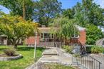 Renovated ranch with over 1, 800 square feet of usable space, including a 738 SF full finished walk-out basement with heat and high ceilings. The main level features an inviting stone-faced wood-burning fireplace in the living room, a dining area with soaring ceilings, two skylights, and sliders to the deck and bi-level patio, and a large, windowed, open kitchen with excellent storage that ties it all together. Two bedrooms and a full hall bath sit alongside the primary bedroom with its own ensuite bathroom.Downstairs, the above-ground, heated, finished walk-out basement is approximately 738SF and includes a separate entrance, full bathroom, large windows, high ceilings, a wet bar, access to the attached one-car garage, laundry, and multiple areas to enjoy. Outdoors, the deck and bi-level patio feature a relaxing hot tub, storage shed, and a large picnic areaâ€”perfect for entertaining, a leisurely game of bocce ball, or just unwinding. Additional features include a new roof, new windows and insulation throughout, recent boiler and HVAC upgrades, landscaping improvements, gleaming hardwood floors, and a full drop-down attic for extra storage. Move-in ready and waiting for youâ€”schedule your visit today!