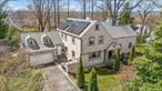 Welcome to a home of unparalleled elegance and comfort at 191 Dunwoodie Street in Yonkers, NY. This magnificent Colonial residence is a true gem, offering 4, 604 square feet of luxurious living space on a sprawling 28, 776 square foot corner lot. Step inside this captivating home to find five spacious bedrooms and five and a half beautifully appointed bathrooms. A grand foyer welcomes you with exquisite hardwood floors that flow seamlessly throughout. The heart of the home is a kitchen, equipped with stainless steel appliances, a dishwasher, microwave, and a generous eat-in dining area. Adjacent, the formal dining room and grand living spaces are perfect for entertaining, with a cozy fireplace. The home features an array of modern conveniences, including central air conditioning, gas heat, hot water heating, and radiant heat for optimal comfort. The private outdoor spaces are unparalleled, with a patio perfect for alfresco dining and a common outdoor area for relaxation. For practicality, enjoy an attached garage, driveway, and full basement providing ample storage and functionality. The elegant spiral staircase leads to serene bedrooms, many with walk-in closets, ensuring ample space for all your needs. Experience luxurious living at its finest in this elegant, personable home that perfectly blends classic charm with modern amenities.
