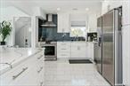 Two-family luxury with rental income potential in the beautiful Gibson neighborhood â€” this fully renovated Valley Stream home combines modern elegance with smart investment value. Bright and stylish, it features a chefâ€™s kitchen with stainless steel appliances and hood, radiant heated tile floors, studio-quality speakers throughout, and a private deck with a 2-car garage, offering both upscale living and strong income from each floor