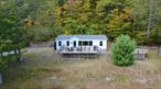 Hudson Valley Panoramic Views - 18.61 Acres with Additional 64 Acres of land Available. Enjoy complete privacy and breathtaking Hudson Valley views from this beautifully remodeled manufactured home on 18.61 surveyed acres. Featuring 3 bedrooms, 2 baths, the home was fully renovated in 2014 with warm knotty pine walls, an inviting open kitchen and living room, and a cast iron wood stove perfect for cozy evenings. Relax on the front tiered deck designed to maximize the incredible views. Updates include new windows, a roof and gutters only 2 years old, plus central air for year-round comfort. An additional 64 acres bordering state land is also available for 200, 000, offering endless recreation potential. The acreage includes a 50-foot right of way through the subject property for access. Tax map #184.00-2-1. Please note: this home is not on a town-maintained road, and there is no road maintenance agreement in place. Don&rsquo;t miss this private Hudson Valley retreat with unmatched views and room to expand!