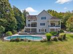 STUNNING custom build offering the ultimate in luxury living -- 4, 120 square feet over three levels, built in 2003, and featuring 5 bedrooms (including the second floor dedicated to the primary en suite only), 3 full bathrooms, a gorgeous saltwater/gunite/heated in-ground pool, and sitting on 2.6 bucolic acres. This property has been meticulously cared for -- and updated even more -- by the current owners, and it shows from the moment you walk in the door. The photos really tell the story of this gorgeous property, but here are some key details . . . sits on a cul-de-sac with just 4 other properties on the road . . . enter home to dramatic living/great room with 18-foot ceilings, stone fireplace, and oversized sliders leading to rear covered balcony overlooking pool . . . open floor plan features chef&rsquo;s kitchen with all the bells and whistles, as well as a pantry . . . formal dining area just off the kitchen, which leads to an office/den with access to another rear balcony (also covered) . . . main floor includes two bedrooms, a full bath and a laundry room . . . upstairs (2nd floor) is the primary en suite, featuring a sitting room, oversized walk-in closet/dressig room,  a luxury bathroom with dual vanity and whirpool tub, and a private deck overlooking the pool. . . . the lower level includes 2 more bedrooms, a full bath, family room, 2-car garage, and glass doors leading out to the pool area . . . property also includes a detached outbuilding, which is finished and heated -- great office/work space . . . . . . Private setting, yet just minutes from the Village of Warwick and all it has to offer, not to mention hiking, skiing, boating, entertainment, fantastic dining options, orchards, Farmers Markets, wineries, breweries, bike/walking trails, drive-in movie, bowling alley, schools, library, hospital, and so much more. Ideal commuter spot, too. This home and property has everything you need -- just move right in and unpack!