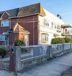This charming semi-detached corner brick two-family home is located in the highly desirable neighborhood of Saint Albans, NY. Currently being used as a one-family home, this property boasts 2, 070 sq. feet of living space, with 5 spacious bedrooms and 4 full baths. The house also includes a fully finished basement with two separate entrances, offering great potential for additional use.The main level features a foyer with a coat closet. The large living room with a faux fireplace is perfect for entertaining. The full kitchen offers open entertaining, ready for your own custom upgrades and renovations, creating an ideal space for cooking and an open dining room. An extension was built on the house to create a 1st floor bedroom, ideal for large families. The second floor offers 4 Bedrooms and 2 Bathrooms; the Primary bedroom has an en-suite bath with a Jacuzzi tub and skylights with a private balcony. There is a laundry room with a hookup for the washer and dryer, with ample closet space.The home is awaiting your personal touch and offers the flexibility to be converted back into a multi-family setup, thanks to its R3-2 zoning, allowing you to generate rental income. Additional highlights include a driveway for extra parking and convenient street parking. The house needs a new boiler.Ideally located, this home is just minutes away from the Saint Albans stop on the Long Island Railroad, providing easy access to the city. It&rsquo;s also within a short distance of the subway, schools, and parks, offering both comfort and convenience in a prime location.
