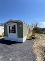 Welcome to your brand-new home! This beautiful 2024-built 2-bedroom, 2-bathroom mobile home offers 900+ square feet of thoughtfully designed living space â€” perfectly blending comfort, style, and affordability. Features Include:Open-Concept Living Area: Spacious layout filled with natural light, featuring stylish wood-look flooring throughout.Modern Kitchen: Equipped with brand-new stainless steel appliances, rich wood cabinetry, and a large peninsula for dining and entertaining.Primary Suite: Large bedroom with attached full bathroom for privacy and convenience.Energy-Efficient Construction: New systems and appliances ensure lower utility costs.Outdoor Space: Private front porch and newly built steps, with a paved driveway for easy parking.Peaceful Setting: Located in a quiet, professionally managed community with open views and a relaxed atmosphere.Home sale is contingent on park approval and lease of the Lot. No real property is being sold just the new Mobile Homes.