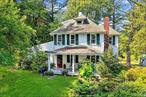 In the Hamlet of Huntersville, this picturesque circa 1920 farmhouse sits privately on almost 1.8 bucolic acres. The welcoming covered rocking chair front porch is mesmerizing and ideal for watching the world go by. The wide plank floors, custom built ins, brick fireplace and more add up to a magical experience. While sitting in the sunroom overlooking the grounds again the experience is breathtaking. Strolling the grounds through garden paths has the feeling of an English Garden. Live on Hunterbrook Road, the longest road in Yorktown with fieldstone walls and a relaxed, serene lifestyle. All this convenient to NYC by either car or train in an hour. Huntersville, Westchester&rsquo;s best kept secret.