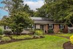 professionally landscaped front yard, oversized lot, new kitchen opens to den with wood burning fireplace, partially finished basement with outside entry, oversized driveway offers ample off street parking