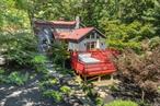 This beautifully updated, turnkey farmhouse on four private acres thoughtfully combines rustic character with modern updates, offering everything you need for the perfect upstate home. A circular drive and bluestone walkways lead to the welcoming covered entry framed by stone walls and mature trees. Inside, exposed beams, wide-plank hardwood floors, and a dramatic stone fireplace reflect the home&rsquo;s 1900s origins, while thoughtful renovations add modern comfort. At the heart of the home, the well-appointed kitchen connects seamlessly to a spacious dining room and features custom cabinetry, stone counters, and a Wolf gas stove. A separate walk-in pantry provides ample storage, while an additional living room/home office offers flexible space to suit your lifestyle. Two more living areas - a cozy living room and a spacious family room - provide options for both gathering and quiet downtime. The cozy living room offers a flexible retreat equally suited for movie nights, curling up with a book, or even doubling as guest sleeping space when the house is full. From the bright family room with its exposed beams and cathedral ceiling, French doors open onto a spacious wraparound deck, perfect for cooking, dining, and relaxing while surrounded by woodland views and the sounds of nature. A newly renovated half bath with laundry completes the main floor.Upstairs, the primary suite is bright and serene, with stained-glass details and a thoughtfully renovated ensuite bathroom. Two additional bedrooms and another full bath round out the second floor. The outdoor spaces make this property truly special. A recently installed hot tub invites year-round enjoyment, while a bluestone patio with fire pit is an ideal setting for evenings under the stars. Stone pathways meander through the landscaped grounds, complete with a small ornamental pond linking shady woodland corners with sunny open spaces. The fenced, heated in-ground saline pool provides the perfect place to relax on warm summer days, enhancing the sense of retreat and connection to nature.Practical updates include a durable metal roof and a backup generator for peace of mind. With strong appeal for buyers seeking a second home or authentic Hudson Valley escape, the property is equally ideal as a full-time residence and also offers attractive income potential for those interested in rental opportunities. Conveniently located between Kingston and Stone Ridge, with easy access to the Ashokan Rail Trail and a wide array of cultural, shopping, dining, and outdoor experiences, the home lies just 90 miles from New York City via Exit 19 of the Thruway. 125 Johnson Hill Road offers the best of both worlds: a peaceful private retreat with easy access to everything the Hudson Valley has to offer. Accepted offer on 9/27/2025