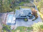 Welcome to 94 Starlight, set on 5 privately wooded acres with a new 14x36 heated salt water in ground pool, views of swinging bridge along with private dock access to the lake. Pool features 8ft sundeck with 2 lounge chairs along with lighted bubbler fountain and wall to wall stairs leading to the deep end section. Pool is lighted for night swims. Home has recently been fully remodeled and features 5 bedrooms and 3.5 full bathrooms and sits at 4963 sqft in total. In addition there is a 3 car attached garage along with long paved driveway. Inside features new wide plank wood flooring through out. Main level features grand formal foyer . Total kitchen upgrade featuring quartz counter tops, new appliances and cabinetry stone back splash. Window by the sink with views of the lake. Propane cook top with vent, formal dining area, half bathroom also fully renovated. Family room with wood burning fireplace along with sliders facing the lake providing access to deck overlooking front yard along with lake views. Formal dining area with mini split units for AC along with sliders out to deck facing lake. Laundry room off of kitchen along with office featuring second set of sliders leading to deck and pool. Upstairs features 3 bedrooms and 2 full bathrooms. Large main suite that features Juliet balcony with lake views, along with custom full bathroom with tiled shower with seat glass doors, along with large soaking tub. Main bedroom has mini splits for ac or secondary source of heat. Two generous size bedrooms along with a second fully renovated full bathroom upstairs. Finished walkout basement has bonus family room along with 2 full bedroom sliders to ground level access and the front yard and a 3rd fully renovated bathroom. Home is across the street from the lake and does have a private dock slip in a gated area for Swinging Bridge Overlook members only.