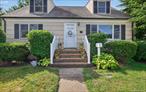 Welcome to this beautifully maintained expanded Cape set on a picturesque, fenced corner lot in South Amityville. Bordered by vibrant landscaping, this home offers both charm and comfort inside and out. Step into a sun-filled living room highlighted by a brand new gas fireplace with a striking stone surround. The open layout flows seamlessly into the dining room and kitchen, where you&rsquo;ll find abundant cabinetry, shelving for display, ample counter space and a brand new gas range, all accented by new luxury vinyl flooring. Two spacious bedrooms and a full bath on the main level provide versatility for family, guests or a home office. Upstairs, the inviting primary bedroom features a custom closet, storage eaves and plenty of natural light. A generous full bath with room for extra linens sits just outside, along with another bright bedroom and access to an adjoining attic with a big closet. The full basement offers endless storage, laundry, an additional refrigerator, and a sink. Recent updates include a new deck with a retractable awning, Hunter Douglas wooden blinds, in ground sprinklers and more. This private, beautifully landscaped yard is the perfect retreat for relaxation or entertaining. The lovingly cared for home blends classic cottage charm with modern updates, ready to welcome its next owners.