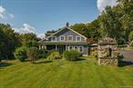 Step back in time and experience the charm of a bygone era with this stately 1835 Colonial home, once owned by retail magnate J.C. Penney and originally serving as the farmhouse for the legendary 1, 000-acre Emmadine Farm. Rich in history and full of character, this 5-bedroom, 2.5-bath residence blends old-world elegance with modern comforts, offering over 3, 765 square feet of thoughtfully updated living space.At the heart of the home lies a large gourmet kitchen, designed to bring people together. With two walk in pantries, a wine fridge, and an ice maker, this space is as functional as it is inviting. Ideal for lively gatherings or quiet mornings by the fireplace. Just off the kitchen, the formal dining room boasts a tin ceiling and an ornate built-in speakeasy cabinet, complete with a hidden Prohibition-era compartment that whispers stories of another time. Step through the French doors and find yourself on a grand wraparound porch, where summer evenings and starlit conversations await.The center hallway leads to a spacious sitting room, anchored by a massive Adirondack-style stone fireplace and a new wood-burning stove. Double French doors open to invite in the breeze or lead to the porch. Thereâ€™s also a dedicated office, a laundry room, and a private parlor that offers a quiet retreat that leads out to heated saltwater pool. Upstairs, five bedrooms await. The prodigious primary suite offers an en-suite bathroom with claw foot bath and walk in closet which is rare for the era. Two larger bedrooms provide ample natural light and storage, while two cozier rooms mirror each other across the landing. Down the hall, a generous walk in linen closet with built-in drawers and cubbies adds to the homeâ€™s thoughtful touches.Recent updates include a new indirect water heater. The pool area, floating deck, and landscaping were designed and installed within the last two years. The property also features a new septic tank with an easy-access standoff.Located just 59 miles from Manhattan, with easy access to both New Hamburg (7 miles) and Beacon (12 miles) train stations, this home offers the perfect balance of countryside serenity and commuter convenience. Just a short drive to Wappingers Falls, Poughkeepsie Galleria, and Newburgh Airport, itâ€™s ideally situated for both weekend escapes and year-round living.This historic treasure wonâ€™t last long. To learn more, visit www.upstatedown.com/thejcpennyhouse and schedule your private tour today.