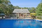 Set on .65 acres, this peaceful Hamptons retreat is just 3.5 miles from East Hampton Village and minutes from Maidstone Beach and acclaimed waterfront restaurants. Featuring 4 bedrooms and 3.5 baths, including a first-floor en-suite, the home offers both comfort and flexibility. The spacious great room with cathedral ceilings, hardwood flooring, gas fireplace, and a chef&rsquo;s kitchen sets the stage for easy entertaining. A bright sunroom opens to the deck and 20x40 pool, creating the ultimate indoor-outdoor lifestyle. The zen-inspired lower level with a full bath and steam shower completes this inviting, spa-like escape. Come discover where Hamptons charm meets modern comfort.