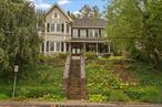 This rare antique Victorian in Northport Village blends historic charm with modern convenience. Built-in 1896, this architectural gem features 10-ft ceilings, original molding, hardwood floors, tin ceilings, and stunning craftsmanship. The main level boasts a living room, sitting room, sunroom, full bath with clawfoot tub, and an open kitchen-dining area with stainless steel appliances and granite countertops. Upstairs, three spacious bedrooms, a full bath, and a primary suite with a coffered ceiling, Venetian plaster walls, and ample storage. The outdoor space includes a covered mahogany porch, fenced courtyard, koi pond, and a bluestone patio. Private parking for three cars is accessible via a deeded road. With brand-new windows, natural gas, CAC & public sewers, this is a rare find just one block from Main Streetâ€™s restaurants, shops, and parks!