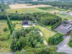 Beautiful 19.9 acres of cleared farmland across three tax lots (8.6 acres, 8.6 acres, and 2.7 acres). The property features a 7-stall barn with tack room, bathroom, and wash stall, plus a 4-stall shed row barn, multiple paddocks, and a lighted riding arenaâ€”ideal for equestrian use.Although the residence was recently lost to fire, the foundation, driveway, pool, and landscaping remain, creating a ready site to rebuild the home of your dreams. Utilities are already in place: electric, and well water are active, with electric and water also connected to the barns.Additional improvements include a detached garage and shed (both with electric), along with two active wells and one dormant well. This rare offering combines infrastructure, open acreage, and equestrian amenities in a prime setting.