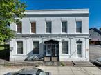 Welcome to 19 Main Street, an exceptional opportunity to own a spacious and versatile commercial building located in the heart of the Hamlet of Wallkill. This solidly constructed two-story building, including a full basement and attached rear structure, offers a total of approximately 5, 911 square feet of interior space on an 8, 200 sq ft lot. Previously used as a professional office space, this property is well-suited for a wide range of commercial or potential residential redevelopment opportunities (with appropriate approvals).As you approach the property, youâ€™ll notice its prominent street frontage and excellent visibility on a well-traveled local road. The building sits in a high-traffic area with strong community presence and is surrounded by local businesses, schools, parks, and residential neighborhoods, offering convenient access for employees, customers, or tenants alike. The main structure features large, open rooms with flexible floor plans that can easily be adapted to meet a variety of business or organizational needs. Both floors offer expansive spaces, ideal for professional offices, medical or wellness practices, retail showrooms, educational or training centers, or creative studios. With multiple entry points and a full basement, the building layout allows for single or multi-tenant use.The rear attached structure includes a handicap-accessible ramp, ensuring compliance and accessibility for all clients and visitors. Inside, youâ€™ll find multiple bathrooms strategically located throughout the building for convenience, as well as ample natural light from the many windows that line the perimeter. The overall interior layout provides a functional flow that can be easily customized or subdivided.Infrastructure highlights include connection to commercial municipal water and sewer, which adds significant value and lowers operational hurdles for many business types. The 8, 200 sq ft lot offers ample road frontage, creating excellent signage opportunities and visibility from the street, which is ideal for any business seeking exposure in a growing, walkable hamlet setting. This property is located in a desirable and revitalizing area, making it an ideal investment for developers, business owners, or investors looking for a long-term income-producing asset. The Hamlet of Wallkill continues to grow in popularity, offering a small-town atmosphere while still being conveniently located near major roads and regional hubs. With its size, flexibility, infrastructure, and location, this building is a blank canvas ready to be transformed to suit your needsâ€”whether thatâ€™s continuing as a professional office building, developing multiple rental units, creating a community-based center, or exploring a live/work arrangement. Don&rsquo;t miss this unique opportunity to own a well-located, generously sized, and adaptable commercial property in one of the Hudson Valleyâ€™s most charming hamlet communities. Bring your vision and unlock the full potential of this one-of-a-kind space. Book your showing today!