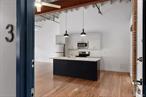 This spacious 1 bedroom fully updated loft apartment features high ceilings, open layout, exposed brick and beams, large windows and custom blinds. It showcases a modern kitchen with stainless steel appliances, wood cabinets and quartz countertops and oversized kitchen island. The bathroom feature sradiant heated floors, ceramic tiling, glass shower doors and quartz countertops. This apartment is located in the Mill + Main complex and has 7 lofts. The building features; fob access, exterior cameras, laundry on the floor, 1 parking spot per loft, heating and air conditioning and elevato r access. Loft 3 is the largest 1 bedroom/Junior 4 apartment with oversized windows, very high ceilings, tons of living space & custom closets. This urban location is the ultimate for shopping, dining and close to the train. Be wowed by these new renovated Lofts.