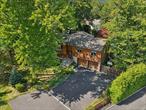 Tappan, NY. Are you looking for a home that is as special as you are? Then you must see this exceptional and thoughtfully expanded home with a sensational backyard resort including a heated inground pool, hot tub, and multiple decks and patios. As you step inside, you are welcomed by a skylit living room with a bay window allowing for a tremendous amount of natural light. You will love the easy flow into the pristine kitchen with its custom wood cabinetry, stainless appliances and crisp, white-tiled backsplash. The dining room is equally perfect for enjoying quiet dinners at home as well as for celebrating holidays with friends and family. A special highlight is the fantastic -300 sf sunroom addition with its wall of windows overlooking the gorgeous backyard. Perfect as a family room/reading nook, homework station or just a great spot to relax and take in the view. A stylish wrought iron spiral staircase provides access to the lower level. You will also find the primary bedroom with a private en suite bath, two additional bedrooms and another full bath on this level. The walkout lower level was also expanded to create an almost 400 sf family room with exposed brick hearth with woodburning stove for those cold winter nights, built-in floor to ceiling bookshelves and a bonus room great for a home office, gym or whatever you like. Rounding out this level is an additional bedroom, convenient half bath and the laundry room. Set back off the road on .41 custom landscaped acres and backing to over 36 acres of county-owned land, the backyard offers unparalleled privacy. You will be thrilled to learn you are just moments away from all major roadways and only about 14 miles from the GWB making for an easy commute to just about everywhere. Located in award-winning South Orangetown schools with universal pre-K. Tons of recreational activities nearbyâ€”hiking, biking, sailing, baseball and soccer fields, parks and playgrounds. All this and so much more.Donâ€™t wait; call now.