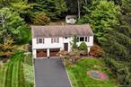 Welcome to this well-cared-for and maintenance free 3-bedroom, 2.5-bath home set on .37 acres in one of Harrimanâ€™s most desirable neighborhoods. Ideally located just minutes to the Harriman train station and commuter bus parking to NYC, this property offers both convenience and comfort. This spacious 45-foot bi-level features a bright, two-story entry and open layout with generous room sizes. The main level offers a large living room, dining area, and eat-in- kitchen with stainless steel appliances and laminate flooring with access to an oversized Trex deck-perfect for outdoor dining and entertaining. The primary suite includes a private bath, with stall shower,  while two additional bedrooms share a full hall bath. The lower level provides a versatile family room (possible 4th bedrm) , half bath, laundry and walk-out access through the two car garage.  Outdoors, enjoy the professionally landscaped grounds with mature plantings complete with a lawn sprinkler system, sidewalks, and underground utilities plus additional storage shed. Close to Harriman State Park with over 200 trails, minutes to Monroe Woodbury outlets and easy access to NYS Thruway. Excellent Monroe Woodbury Schools! LOW TAXES ! Original owners! .Pride of ownership shines throughâ€”this move-in ready home is waiting for you!
