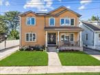 Welcome to this beautifully updated 5-bedroom , 3 full bath home in the heart of Elmont. originally remodeled back in 2016, this spacious residence blends modern comfort with thoughtful design. The main level features gleaming wood floors, a bright open layout, a kitchen with stainless steel appliances throughout. A finished basement offers plenty of additional space, perfect for entertaining or relaxing. The home is equipped with 2-zone central air/heat for year round comfort. Enjoy your second floor balcony with views of the sunrise or sunset. Outside, enjoy a large paved backyard complete with gazebo, ideal for gatherings. Parking is never an issue with a garage and two full driveways. Solar panels are leased @ $185 a month which is transferrable. Convenience continues with a washer and dryer located just outside the primary suite. With its generous space, functional updates this home is ready to welcome its new owners!