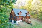 Have you ever dreamed of owning a cabin in the woods? A place away from the hustle and bustle where you can relax and tune-in to nature? Tucked away on a quiet secondary road in the scenic Western Catskills, this meticulously-maintained log home provides the perfect blend of rustic charm and modern comfort, plus the peace and privacy you are looking for. Inside you will find a spacious open-concept two-story space, with living, dining and kitchen areas, beneath a soaring cathedral ceiling. The centerpiece of this great space is a stunning floor-to-ceiling stone fireplace. Natural light enters from windows on three sides and two sets of large glass doors that open onto an expansive rear deck thatâ€™s perfect for outdoor dining, or relaxing in the tranquil surroundings. An east-oriented covered front porch provides an ideal spot to quietly start your day as the sun peaks through the woods, and the natural would awakens. Features of the well-appointed kitchen include hickory wood cabinets, granite countertops plus an island. Beyond the kitchen, accessed via a short hallway, are two generously-sized bedrooms plus a full bathroom. Hardwood flooring runs throughout the main living space and bedrooms. Floor is radiant-heated and can be controlled remotely. A loft that overlooks the great room is accessed via a wide rustic-railed staircase and provides space for an office, lounging area, or reading nook. Beyond the loft is the private primary bedroom suite. The finished basement provides more living space and is ideal for creating a cozy den, recreation room and/or hobby space. Two large sliding barn doors provide access to laundry area and well-organized utilities space. Heat is provided by a separate zone of radiant heating. A large two-car garage, adjacent to the finished basement, provides covered access from car to house. Beyond the house lies 7 acres of hillside woodland, that has a creek running through, and is teaming with wildlife, ferns, and mosses. The property is ideal for creating your own private hiking trail and perfect for snow-shoeing in Winter. Nearby townsâ€”Livingston Manor, Youngsville, Jeffersonville, Callicoon and Roscoeâ€”provide great shopping, dining, and brewery options, and the area benefits from having a vibrant and growing arts community; the Bethel Woods Center for the Arts is just 20 minutes away and Catskill Art Space is 10 minutes away in Livingston Manor. The area is famous for fly fishing, and provides many opportunities for outdoor pursuits, such as hiking, swimming and kayaking.Schedule a viewing to see all that this property has to offer. Move quickly and you can have keys in time to host a memorable Thanksgiving or Holiday gathering.