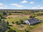 Unique Barndominium on 10 beautiful farm acres in Dutchess County! Set on gently rolling fields, this one-of-a-kind Barndominium offers an open, airy layout with abundant natural light - creating the perfect backdrop for country living, equestrian sports, or a weekend getaway. Ideal horse property with attached 6-stall barn, wash stall and feed/tack room. TEN gorgeous acres including a fully engineered, soon to be approved new home site. Considering hobby farm living? This property has plenty of room for gardens, animals, paddocks or a chicken coop. The living space is attached to the barn (talk about easy to feed the horses in bad weather!)! Enjoy wide-open views, peaceful country living, and a convenient location just minutes to shops, schools, and commuter routes. Brand new roof was just installed in September! Whether youâ€™re dreaming of horses in the pasture, fresh eggs in the morning, or simply a place to spread out and enjoy nature, this Lagrangeville Barndominium offers the lifestyle youâ€™ve been looking for. If you are looking for a large creative space or an art studio, the barn can be used as a huge workshop. The barn-side dimensions are approximately 36 x 40 (total structure including living space is 36 x 60), this property is suitable for many different purposes. Seller is in the process of subdividing from a larger parcel. Additional land may be available.