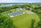 AVALON FARM. A phenomenal, state-of-the-art 23+ acre equestrian boarding facility with 25 stalls in the heart of North Salem. Completely renovated 19th century main barn with 18 rubber mattress stalls, 2 heated wash stalls, multiple tack rooms, office, powder room, laundry, and incredible upper hayloft with barreled ceiling. 4 and 3 stall guest barns with own tack and feed room. One of a kind 100 x 200 indoor riding arena with Lawton Adams TravelRight footing, safety soft impact kick boards, no avalanche pitched roof, ventilation system and 12 automatic garage style glass doors that with a push of a button, can be converted to a covered ring in the summer. Climate-controlled viewing lounge and powder room with full audio speaker system for indoor. 120â€™ x 200â€™ outdoor riding arena with Lawton Adams footing. All traffic areas feature Eco Raster â€˜no mudâ€™ system. Heated path from main barn to Indoor Ring. Numerous rolling grass turnout paddocks with water and electricity. Medical paddocks. 1 bedroom and 2 bedroom + office staff apartments. Large 4 bay garage for equipment storage. High end renovation of 3 bedroom, 2.5 bath colonial cottage with covered outdoor spa entertaining area. The property abuts the 58 acre North Salem Open Land Foundation&rsquo;s Gaymark Preserve with direct access to the NSBTA Trail system. The property is also a biodynamic farm and currently produces an incredible array of organic fruits, vegetables, milk, and eggs. Generator with 5000 gallon underground propane tank supports farm buildings. This facility features all of the amenities the accomplished professional could desire while being located less than 3 miles from International Show jumping venue Old Salem Farm and other top shows. Close proximity to NYC, airports, highways and excellent restaurants. Located in an Agricultural District. Delightful farm to suit all members of your family. Agricultural Exemption Savings of $47, 317.21. Total taxes are $25, 224.31