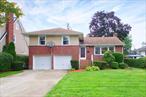 Updated 3 bedroom, 2.5 bath Brick Split-level home situated on a beautiful 60 x 124 lot in the Western section of Garden City. Spacious and bright with an open floor plan, the main level features a living room with oversized picture window, dining area, newly renovated eat-in kitchen with steps down to a powder room and den/ family room with access to the enormous backyard. Upstairs you will find a private master bedroom with renovated ensuite bathroom, 2 additional guest bedrooms and 1 full updated hallway bathroom. Additional highlights include: 2 car attached garage, double wide driveway, attic, partially finished basement, low taxes and close proximity to shops and LIRR. Truly, a must see!