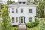 Welcome to 50 Spring Street at President&rsquo;s Place, a spacious home rich in History, Warmth and Charm. A beautiful Center Hall Colonial built in 1875, gracefully perched a few blocks above the waterfront in Kingston&rsquo;s historic Rondout District. The Rondout neighborhood is one of the most coveted areas in the wildly popular destination town of Kingston. Kingston is the Gateway to the Catskill Mountains, set on the majestic Hudson River. Many enjoy boating, fishing and water sports on the Rondout Creek and the Hudson River, and hiking or biking the many nearby trails. You&rsquo;ll step back in time the moment you enter the front foyer where soaring coffered ceilings, an elegant staircase with hand-carved newel posts, and eight foot tall pocket doors welcome you. Throughout the home you will find original chestnut woodwork plus two monumental stained glass windows. As you enter the home, to the left is the parlor (or possible 5th/guest bedroom) with elegant bay windows and high ceilings adjacent to the downstairs full bathroom. To the right is a gracious living room also through an impressive large chestnut pocket door. A beautiful mirrored fireplace and mantle, fabulous hardwood floors, as well as fantastic light from the many tall windows make this an elegant room. Yet another set of pocket doors leads to a light-filled, Thanksgiving-sized dining room which invites large gatherings. A true nod to the home&rsquo;s past is the butler&rsquo;s pantryâ€”with its original dumbwaiter still intactâ€”and glass front cabinets to display your fine dishware and glassware. It connects the dining room to a large, thoughtfully updated kitchen and pantry that perfectly balance modern convenience with timeless character. Just beyond the kitchen, step out to a private blue stone patio and lush gardenâ€”your own quiet retreat. Upstairs, you&rsquo;ll find four spacious light-filled bedrooms, including one with an en-suite full bath. Another full bath is down the hall. The top floor is an incredibly large, unfinished attic with an impressive 16&rsquo; peak, with hints of the original maid&rsquo;s quarters still present. The full basement showcases its historic stone foundation with several smaller rooms, offering the perfect opportunity to create a wine cellar, workshop, or additional storage. There is off-street parking for two cars (one featuring an EV charger. This treasure is just a short walk to the waterfront where you can enjoy wonderful restaurants, hunt for treasures in antique shops and galleries, hop on the rail trail, and soak up everything that makes Kingston&rsquo;s Strand the place to be!
