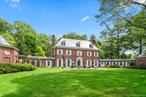 OLD WESTBURY. ICONIC COLONIAL-REVIVAL MANOR - Set on 2.26 private acres, this 1932 William Lawrence Bottomleyâ€“designed Colonial-Revival estate is distinguished by its remarkable architectural form. A four-story brick center residence is flanked by two sweeping first-floor wings that extend in a graceful semi-circle, creating both symmetry and a sense of grandeur rarely seen. Inside, timeless details include a dramatic spiral floating staircase, arched windows, intricate moldings, multiple fireplaces, and light-filled entertaining spaces. The home features 6 bedrooms, 5 full and 3 half baths, including a regal primary suite with study, dual baths, and walk-in closets. Elegant gathering rooms include a banquet-sized dining room, a solarium with wet bar and billiards area, and a stunning octagonal library with imported, fluted, conical ceiling and incredible acoustics. The grounds are equally impressive, offering a heated gunite pool with brick surround, outdoor kitchen, and a pool house with party room, kitchenette, and baths, a circular courtyard with 5 garage bays, and slate and copper roofing complete this one-of-a-kind estate. A must see!!