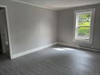 Newly renovated ground-floor apartment. Lots of light. Spacious front living room. Three bedrooms, 1 full bathroom. Washer hook up. Cozy modern kitchen. Two entrances/exits- front porch and small side porch. Extra storage cove and lengthy closet, both off the main hallway. Newly paved parking spaces for tenants. Great location. Center of Woodbourne is literally right next to the Neversink River and local businesses. 15 minutes to Walmart SuperCenter, Garnet Medical Center, most Sullivan County offices, and Liberty.