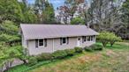 Nestled on 5.05 acres of partially cleared and wooded land, this single-owner Ranch style property in Woodbourne, NY offers privacy, space, and the perks of one level living. The flat lot features a long driveway that leads to an extended Two-car Garage with a door for walk-out access, a large Garden area, and plenty of cleared space to add a Carport, Deck, Pool, or any other exterior features as there is ample room for opportunity.Inside, the Front Entrance opens up to the one-level living layout featuring parquet wood flooring, a recently renovated Bathroom, and three comfortable Bedrooms all on the Main Floor. The spacious Living Room welcomes you with a large picture window overlooking the private front yard, and flows seamlessly into the Dining Room area which has another large window bringing in plenty of natural light and a door with direct access to the backyard stairs. The Kitchen has a functional U-shaped countertop layout, ample cabinetry, and a tinted window above the sink that allows you to let light in while still maintaining your privacy.On the other side of the Main Level is a hallway that leads to 3 Bedrooms with parquet wood floors and the Full Bathroom that has been tastefully updated with a glass door extended-stall shower, tile flooring, and a modern vanity with cabinets. The Lower Level includes an unfinished basement with utilities (boiler, hot water heater, pressure tank) a work area with a work bench, plus a newer washer/dryer (installed 3 years ago). This side of the basement connects to the extended Two-car Garage with a door that provides walk-out access to the driveway.BONUS: An extra hot water heater and above-ground oil tank were added by the owner with the vision of adding radiant heat flooring, though this was never completed, the addition of the never used systems offer the next owner the chance to finish adding radiant heat flooring or select your desired heating options beyond the existing electric heat.Enjoy the beauty and tranquility of Sullivan County while still being close to modern conveniences. Located just 2.5 hours North of NYC, Woodbourne is just miles from the scenic Neversink Reservoir and River, Resorts World Catskills Casino, Bethel Woods Center for the Arts, Minnewaska State Park Preserve and endless outdoor activities like hiking, fishing, and other outdoor recreation. Whether youâ€™re seeking a year-round residence or a second home escape from the hustle and bustle, this property offers endless potential in a serene setting.