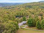 Set on 36 acres along one of the area&rsquo;s most beautiful roads, 898 Gipsy Trail Road feels like a private country retreat overlooking Bird Pond. This estate was built as a place for gathering, with six bedrooms, six bathrooms, and a layout designed to welcome family and friends with ease. The foyer sits at the heart of the home, connecting the spaces that define the main level. To one side, the primary suite offers its own fireplace and a quiet retreat. Nearby, an additional bedroom provides flexibility for guests. The main living room opens to the back deck and frames sweeping lawn and lake views, while the dining room and chefâ€™s kitchen create a natural hub for entertaining. A second living room and a sunroom with a dramatic stone fireplace add yet more options for relaxation in every season. Upstairs, four bedrooms are balanced by a bright family room at the center, ideal for gathering or play. The walk-out lower level extends the living space with a bonus room, two oversized playrooms, a sauna, and a full bath. Outdoors, the property stretches in every direction. Rolling lawns slope down toward the pond, while an expansive pool with pool house anchors the summer setting. More than a house, this is a true compound, an escape that can host generations, while being just minutes to the Trail Club & highways to be in the city in 1 hour.