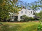 This Town of Warwick Cape on almost an acre features a three-car detached oversized garage with workshop, flowering gardens with waterfall and koi pond. The glass sunroom with hot tub provides warmth during the winter and has access to the fenced heated inground pool with paver patio. Enter into an enclosed front porch and formal living room with fieldstone wood fireplace and built-in shelving. A formal dining room has a brick accent wall with shelving and built-in storage closet. The eat-in kitchen with four oversized windows overlooks the waterfall and koi pond and is updated with stainless steel appliances, five burner range with dual ovens, granite counter, solid wood cabinets and custom backsplash and Old-World Charm from beamed ceiling. Full bath has been remodeled with tub, tile shower, pedestal sink and storage. Laundry and mudroom complete the first floor. Upstairs has two bedrooms, another updated bath with shower, an office and a craft/workshop/storage room. The well was replaced in 2023. Energy efficient solar panels are owned. Property is gently sloped with two additional storage sheds. Located one mile from Warwick Park and Ride for commuting to New York City.