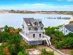 Summer cottage or year-round retreat? Whatever you choose, thereâ€™s no better location in Oak Beach: right along the sandy shores of Sore Thumb Cove. This 4 bed/2 bath waterfront home delivers unparalleled views of the cove, Fire Island, the Atlantic, and the Great South Bay, with roof-deck vistas that span NYC and the Robert Moses Bridge. Spend lazy days basking in the sunlight pouring through the windows or head out to one of the homeâ€™s many decks to sip your morning coffee or enjoy an afternoon refreshment. The centerpiece of the main floor is the open concept living/dining room with windows on three sides and a cozy pellet stove, surrounded by kitchen, bedroom, 3/4 bath, and laundry. On the second floor, two spacious bedrooms overlook the cove and the ocean, while an L-shaped lounge includes views across the bay. A full bath with separate tub and shower, plus vanity with two sinks, completes this level. Sea and bayviews continue on the top floor, which features a bedroom or den and mezzanine with sitting area. Down on the ground level, parking is a breeze. The large garage has room for your car and everything else, while the oversized yard provides extensive parking for guests. All of this is just steps from the beach, where you can swim, kayak, paddleboard, or stroll with your dog overthe dunes and gaze out at the Atlantic. Best of all, this one-of-a-kind waterfront sanctuary is only a ten-minute drive from Montauk Highway in West Islip and less than an hour from NYC. Most furnishings included.