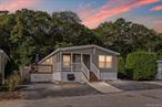 Welcome to this spacious, double-wide manufactured home in a private community offering 3 bedrooms and 2 full baths, including a master ensuite. Featuring an open floor plan with laminate flooring and carpeting, this home is designed for comfort and convenience. Enjoy an adorable front porch, sliders leading to a side deck, and a paver patio for outdoor living. Located near Riverhead outlets, Splish Splash, and North Fork attractions, the pet-friendly park welcomes all ages.