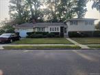 Huge Split on oversized corner lot with street parking on 2 streets . Huge expanded living room with cathedral ceilings and floor to ceiling brick and stone fireplace. Large eat in kitchen and large formal dining room. Oversized Garage 1.5 cars wide by 1.5 cars long. Lower level with bedroom, den, half bath, laundry room and outside entrance. New Paint, Floor coverings, and interior doors Throughout. House being sold as exists. Natural gas forced air heat.