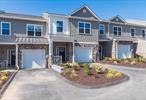 This Magnificent Townhome in Fabulous River Ridge is so new ; it still has the new house smell. And so many upgrades over the standard Townhome. And it sits beautifully on a ridge overlooking the clubhouse and pool. The Kitchen has smooth granite countertops tastefully matched just right to the cabinets. The center island has additional cabinets and seating for 3. Stainless steel appliances match wonderfully and the lighting is modern and is an upgrade. This kitchen is open to the dining area and large livingroom; the floors throughout the main level are stunning engineered hardwood and there is a gas fireplace as the focal point of the livingroom. Sliders lead to a private patio. Take the upgraded wood stairs up to the second level with hardwood flooring in hallway and storage room. Upstairs are 3 large sized bedrooms including the primary with spacious walk-in closet and upgraded bath. This bathroom has upgraded shower and tastefully designed tile. The hall bathroom also is beautifully tiled, an upgrade from the standard. In addition to the bedrooms upstairs is a laundry room and a small room which can be an extra closet or large enough to be a small office if needed. Other upgrades include recessed lighting throughout and a chandelier on order. The large primary bedroom has an upgraded bath and huge walk-in closet. Park in your own spacious one car garage. Beside having this beautiful townhome, the state of the art clubhouse has a media center, pool table, kitchen, new gym, and outside a bocce ball court, shuffleboard and large pool and patio. True country club living in this friendly and welcoming community that has many social events and gatherings. An extra benefit of this brand new townhome is that it is ready for you now, with no waiting!!!