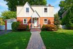 Charming center hall colonial in move in ready condition! This classic 3 bedroom 1 bathroom home is set on a 75x100 lot. The main level has original hardwood floors throughout and a cozy dining room with excellent natural light. The second floor you will find the primary bedroom with two closets and two additional bedrooms with closets and original hardwood floors. Additional highlights include: finished basement, a one car attached garage, Central air conditioning, and a large backyard with a brick patio excellent for entertaining.