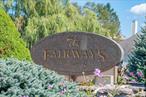 Large town house unit in the beautiful Fairways Community. Bright and airy, this unit features a large first floor bedroom, full bath, laundry, updated kitchen, dining room with wet bar and a living room with wood burning fireplace. Ample closet space, including a convenient storage closet. Upstairs there is a spacious bedroom with vaulted ceilings, double walk-in closets and an extra large bathroom with a soaking jacuzzi tub. The unit has a new washer/dryer, new hot water heater, all new Anderson windows on 2nd floor and a new front door. There are 2 assigned parking spaces and plenty of visitor spots. Hardwood floors throughout, lots of natural light and high ceilings makes this unit feel even larger. The sliders lead to an expansive deck overlooking a beautiful pond with fountain, where you can enjoy a BBQ, peaceful morning coffee and amazing sunsets. This well kept complex has a community pool with lifeguard, playground, picnic area, and sprawling grounds. Close to major highways, shopping and restaurants. Low HOA fee includes ground maintenance, pool, trash, snow removal, water and sewer. Pet friendly community. This unit lives like a single family home with none of the maintenance, enjoy carefree living!