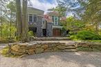 Beautiful custom home built in 1980 on a private road in scenic Pound Ridge. A thoughtful and tasteful full renovation was completed in 2013. The neo-classical post-and-beam design is a unique dwelling with no comparison in its stature and setting.Situated high on a rock ledge with immaculate mature landscaping and ornate treesâ€”from mighty oaks and tall hemlocks to Japanese maples and weeping cherriesâ€”the property is a nature loverâ€™s dream.The property features a 3, 500 sq ft main house with 3 bedrooms and 3.5 bathrooms, and a 1, 500 sq ft 1-bedroom, 1-bathroom guest cottage with a separate driveway. Perfect for guests, ADU, staff living quarters, and/or rental income.The main house features grand stone piers surrounding a large outdoor deck with metal railing and Ipe wood, as well as a spacious stone patio overlooking a 13-foot-deep kidney-shaped heated pool with spillover hot tub, all surrounded by stone. The stone patio includes a built-in stainless steel BBQ, also encased in stone, with an outdoor Viking refrigerator and built-in outdoor speakers for the pool area and patio.Large stone steps lead to the patio and pool area, with a secluded wood walkway to the guest cottage. The pool area feels completely separate and extremely private, yet remains visible from the main house.A large spring-fed pond is great for canoeing and kayaking, and the property includes lake rights to Lake Kitchawan, just a short walk down the private road.The immaculate and well-maintained interior is anchored by a free-floating cantilevered staircase that serves all three floors of the home and becomes an artistic focal point of the house. It features a sunken living room with an open floor plan, plenty of natural light, and a stone-faced wood-burning fireplaceâ€”ideal for hosting guests and parties.The main bedroom feels like a separate guest suite, part of the 2013 addition. This spacious room boasts 20-foot ceilings, pond views, and a walk-in closet.A built-in music system is installed throughout most of the home, along with modern top-of-the-line appliances: Viking range, Miele dishwasher, Liebherr refrigerator, and Whirlpool washer/dryer. The kitchen features granite countertops and is flooded with natural light from three skylights and 20-foot ceilings.Wood floors run throughout the house, with a marble-tiled floor in the front entrance.The home is equipped with natural gas heat and central air, served by one 1, 000-gallon buried tank with stone surround for the main house, and another 1, 000-gallon buried tank for the guest cottage and pool/spa heat.Additional features include an outdoor shower, steam shower in the third-floor bathroom, fire pit, fenced dog pen, shed, gravel driveways, well with water treatment system, gas fireplace with stone surround on the first floor, and great bones.