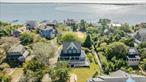Newly Renovated Turn-Key Colonial in Desirable Oak Beach. Welcome to this beautifully renovated Colonial offering year-round living with coastal charm and modern upgrades. A sweeping wraparound porch invites you inside to a bright and open floor plan featuring 9â€™ high ceilings on the first floor and a cozy fireplace, perfect for gatherings. The newly remodeled kitchen shines with quartz countertops, a huge center island, and stainless steel appliances. This home features four spacious bedrooms and 2.5 updated bathrooms, complemented by new vinyl plank flooring, refinished original wood flooring, and abundant natural light through brand-new Andersen windows. Additional upgrades include all-new heating and cooling systems, new vinyl siding, architectural roof, and expansive new deckingâ€”making this property truly turn-key. Nestled in the sought-after Oak Beach community, enjoy the serene lifestyle of the Great South Bay and Fire Island Inlet while still being conveniently close to Robert Moses State Park, Town of Babylon beaches, Fire Island National Seashore, and the Babylon LIRR station. Just a 60-minute drive to New York City, this home offers the perfect balance of waterfront tranquility and modern accessibility. Experience coastal living at its finest!Note: Land lease of $4, 000 annually. Home sold as is.