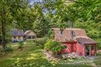 Privately sited on 10 acres, this peaceful retreat is defined by its meandering nature trails, quiet meadows, and a serene pond where turtles bask on the banks and wildlife drifts among the blooming water lilies â€” a perfect spot for an afternoon swim or quiet reflection. Privacy is paramount â€” the property is tucked away down a long, tree-lined driveway, creating a true sanctuary from the outside world. This is a true getaway â€” linger by the pond as dragonflies skim the surface, wander the trails under a canopy of trees, gather friends for a slow afternoon barbecue, and end the day around the firepit as stars fill the night sky. Two charming cottages anchor this idyllic setting, offering a wonderful getaway with friends where everyone can be together yet still enjoy their own private space. The Red House, approximately 1, 000 square feet, features a light-filled open kitchen and living area designed for gathering, two serene bedrooms, and generous storage â€” all wrapped in cozy simplicity. The Yellow House, just under 900 square feet, serves as a gracious guest cottage with a spacious primary suite framing ever-changing views. Sliding doors open to a private deck and yard, where you can breathe in fresh country air and watch the seasons unfold. Between the two cottages is a large firepit â€” the &rsquo;&rsquo;living room&rsquo;&rsquo; of the property â€” where everyone naturally gathers to connect, tell stories, and watch the stars appear overhead. The property also offers easy access to nearby attractions, including the Rondout Reservoir, Peekamoose Blue Hole, and world-class hiking, biking, and skiing â€” making it a perfect four-season escape. Beloved Hudson Valley towns such as New Paltz, Kingston, Accord, and Woodstock are just a short drive away, offering farm-to-table dining, antique shops, trout fishing, and all the culture and charm this region is known for. Whether you&rsquo;re seeking a private retreat, a family compound, or a proven short-term rental investment, this property offers a rare opportunity to own a truly magical slice of the Hudson Valley. With a history of top-rated Airbnb reviews, this charmer promises a wonderful getaway and a turnkey opportunity for the next owner.