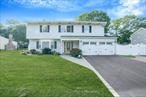 Fall in love with this spacious 4-Bedroom, 2 bath Colonial in the Comsewogue School District! Featuring a gorgeous updated Kitchen with stainless steel appliances, central air, and a walk-in-closet in the primary bedroom. In addition to the spacious primary bedroom, there are 3 more generously sized bedrooms. Enjoy cozy nights by the wood-burning fireplace or entertain on the deck with a private fully fenced yard. Rounding out this beautiful home it offers a new roof and flexible upstairs space with potential for a full bath or home office. This one will not last!