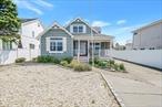 Coastal charm at a value price! This beautiful Cape Cod-style home offers the perfect blend of charm, comfort, and breathtaking water views. This property features access to a sandy beach and a delightful sprinkle park nearby â€” perfect for families and guests of all ages. Step onto the private front porch, where you can relax with your morning coffee or evening cocktail while soaking in sweeping views of the water. As the day winds down, youâ€™ll be treated to spectacular sunsets that paint the sky in shades of orange, pink, and gold. All the benefits of living on the water without the hassle due to being in zone X, a no flood zone. Inside, this home boasts timeless Cape Cod architecture with a warm and inviting interior. Highlights include: Spacious living room with water views. Bright, updated kitchen with modern appliances. Cozy bedrooms filled with natural light. Main floor primary bedroom en suite. Donâ€™t miss your chance to own this slice of paradise - schedule a private showing today!