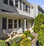 Quiet tri-level unit in Williamsburg Ridge. Well maintained and move-in ready. One of the rare units that boasts a front porch and privacy at the entrance. The bright eat-in kitchen with stainless steel appliances opens to a dining and living area, featuring a marble wood-burning fireplace and slider to the deck with views â€“ perfect for entertaining. The upstairs boasts two bedrooms with ample closet space - a primary bedroom with updated ensuite bath + another spacious bedroom, large linen closet and lovely full hall bath. The lower level includes a finished family room with home office space and slider to rear yard, along with laundry, utilities, and abundant storage. Residents enjoy community amenities including a pool, sports court, and playground. Conveniently located near schools, shopping, restaurants, bike path, Route 6, Taconic Pkwy, and just four miles from the Westchester border, this beautiful and quiet unit is a must-see! Taxes shown do not reflect Basic STAR Deduction, if applicable.