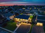 Located on a quiet, private cul-de-sac, this pristine wide-line Hi Ranch offers the perfect blend of luxury, privacy, and waterfront living. The entry foyer leads to a spacious living room with an electric fireplace, formal dining room with access to a second-story balcony overlooking the yard, saltwater gunite pool, hot tub, and 75&rsquo; of waterfront. The custom center-island kitchen includes a large pantry, with stainless steel and Energy Star appliances. The primary suite features a luxurious private bath and an adjacent lavish, custom-designed walk-in wardrobe. Two additional bedrooms and a full bath complete the upper level, which boasts dark walnut-stained hardwood floors. Radiant heat floors are found in all bathrooms and the laundry room. The lower level includes a large bedroom, den with a wood-burning fireplace and ceramic flooring, full bath, cedar closet, oversized laundry room with dual washers/dryers and a custom built in dog washing station to keep your four-legged friends clean and pampered without leaving home, and access to a heated 2-car garage. Upgrades include all new Andersen windows (except three rear), 2023 updates throughout, central air with an additional ductless unit in the primary suite, and a whole-home H2O system. The 75â€™ bulkhead (replaced in 2015) includes a 22, 000-lb boat lift, one jet ski lift, and a dedicated 100-amp dock panel. Flood insurance and elevation certificate available upon request. This home is truly in immaculate, nearly unlived-in conditionâ€”an exceptional waterfront opportunity.