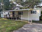 Riverhead 55 + Community and cash only purchases. 2 bed 1 bath, wood floor laminate, washer and dryer, $983.75 lot rent, gas cooking, easy living community, rent covers land lease, water, cesspool, trash, and snow removal.