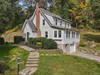 Step into timeless charmâ€”this lovingly renovated antique sits on a peaceful road within walking distance to the Purdys train station. Thoughtfully updated, the home blends enduring character with modern comforts. The private, terraced property with lovely stone walls spans nearly 2 acres across 3 additional tax lots and offers a flagstone patio, play area, fire pit, and chicken coop. Inside, the home features a warm and inviting living room with fireplace, a chefâ€™s kitchen with red oak countertops and a Viking 4-burner gas range, a bright sunroom with new windows and custom bookshelves, a formal dining room, and a beautiful new full bath with laundry. Upstairs youâ€™ll find a stunning newly renovated hall bath and three comfortable bedrooms. Rich in period detail, the home showcases original refinished oak floors, cast-iron baseboard heaters, and windows rebuilt to original specifications with custom storms. A perfect balance of history, charm, and modern living!