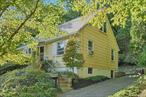 Just over half of a mile, on sidewalk flanked streets, from the Ossining train station and an equal distance to the village&rsquo;s downtown, this wonderful home is perfectly situated for buyers that are looking for convenience, character and comfort. Perched on a verdant, partially wooded lot, with views of the Hudson River, this Cape Cod home is the one you&rsquo;ve been looking for. Park in the driveway, which has room for at least two cars. Up a short flight of steps, past hedges and groundcover, is the front entrance. Come inside to find a good sized living room, with wood floors and abundant natural light flooding in from the large bay window. From another window you can look out to views of the river. The living room opens to the dining area, where you will find an original built-in hutch. The kitchen is efficiently laid out, with a newer fridge and stove. It&rsquo;s well designed for preparing a meal after a long day. The door off the kitchen opens out to the private rear deck, but we&rsquo;ll return to that later. Also on the first floor are two good sized bedrooms and a full hall bathroom, with tub/shower and tile. Upstairs, you will find a third private bedroom with views of its own. An even larger office with extra storage space on this floor is a great bonus. Ceiling fans throughout the living spaces keep air flowing. In the basement you will find an additional large finished space. How might you use this space? A family room, den, cave or just for the extra storage that we all need? Outside again, you can look from the expansive deck to the plantings on your right, the patio on your left, or straight ahead to the steps that wend up the hill to paths which overlook the grounds and look out to the river. All of this, just moments from an express stop to NYC and down the hill from the shops and restaurants of the village of Ossining. Stop by to see all of the possibilities here.